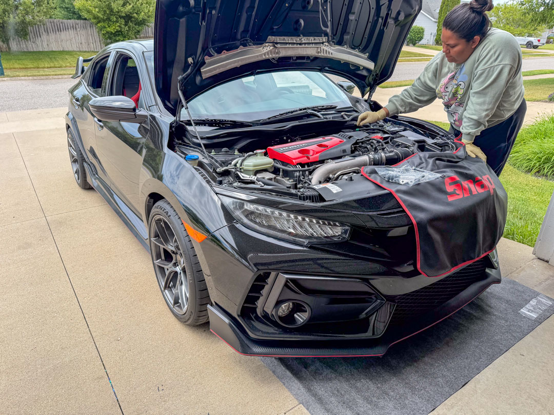 Tommy working under the hood of a vehicle